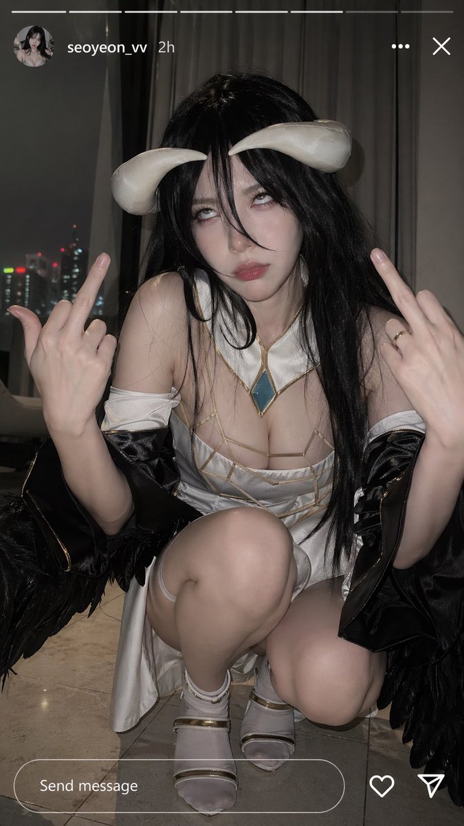 Squatting on the ground, looking directly at the camera
