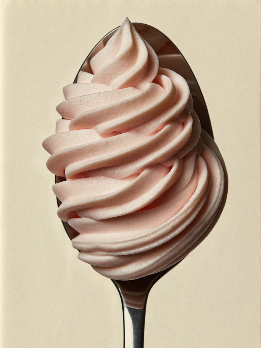 Pink soft-serve ice cream on a spoon